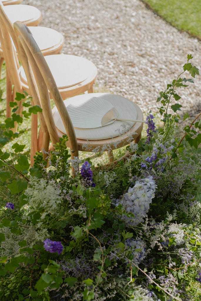 Romantic garden-style wedding flowers featuring mauve, blush, plum, and buttery yellow blooms styled by a wedding florist in San Miguel de Allende, Mexico. The bouquet and floral centerpiece include lisianthus, ranunculus, and delicate filler flowers, perfect for an elegant destination wedding. Captured at Casa Adela with soft candlelight and seasonal fruits, the floral design blends old-world charm with modern romance.