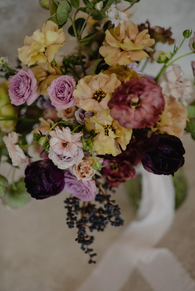 Romantic garden-style wedding flowers featuring mauve, blush, plum, and buttery yellow florals